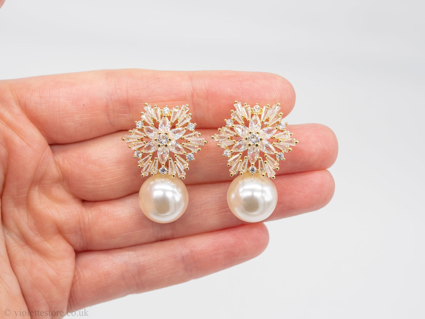 Gold earrings with diamonds and snowflake pearls