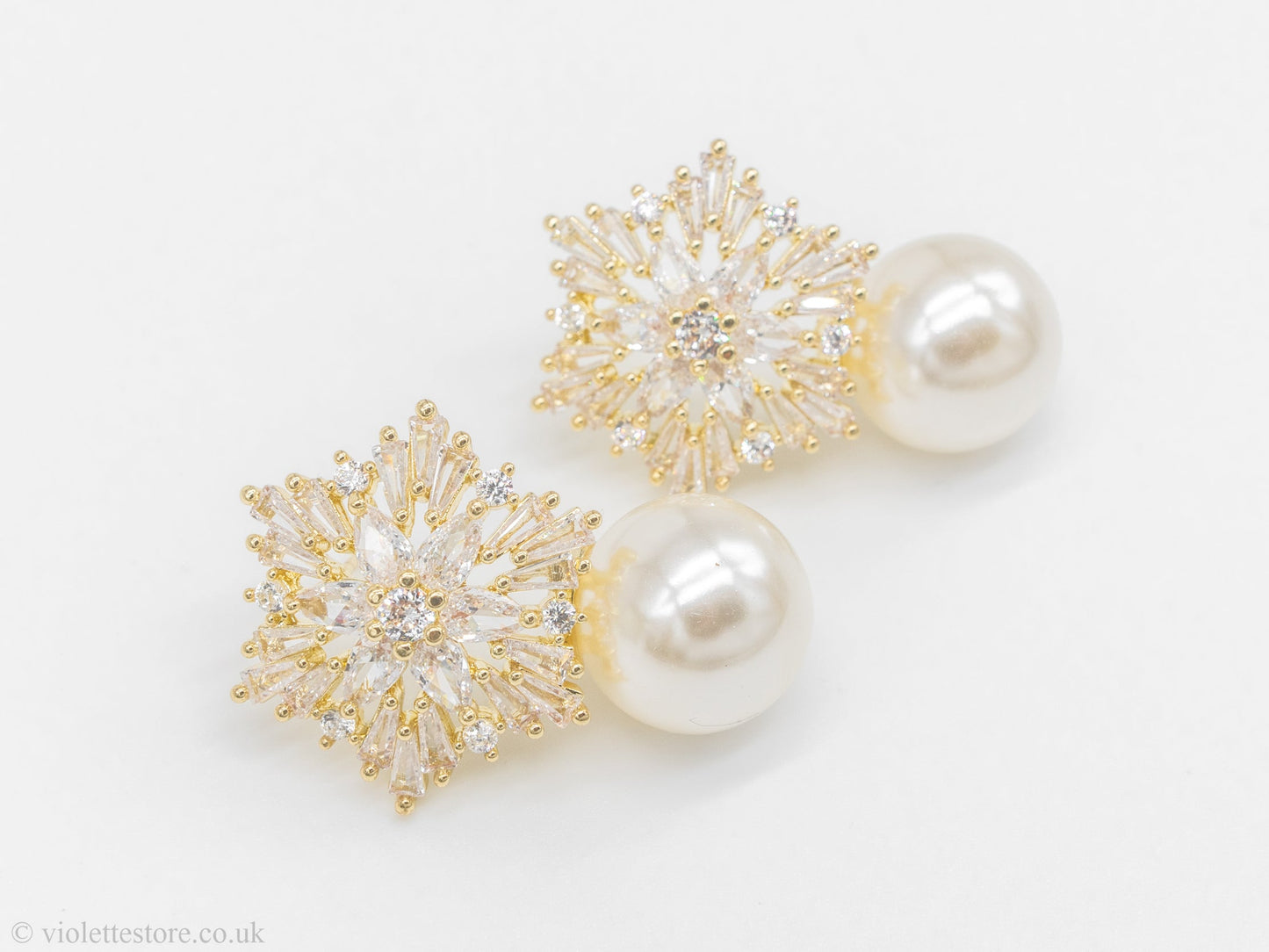 Gold earrings with diamonds and snowflake pearls